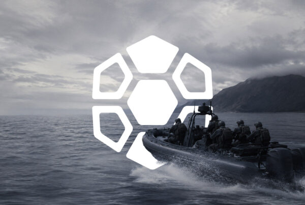 Military special operations team traveling by rigid-hull inflatable boat along a rugged coastline with the Diamondback Solutions geometric brand mark