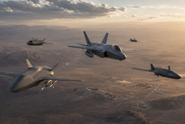 Collaborative Combat Aircraft flying alongside a U.S. military fighter jet during a networked air combat mission